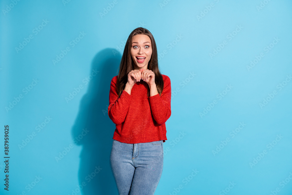 Portrait of careless girl imagine she funny rabbit jumping pullover isolated over blue color background Portrait of careless girl imagine she funny rabbit jumping pullover isolated over blue color background