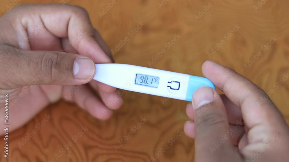 Digital thermometer. Reading body temperature from a thermometer