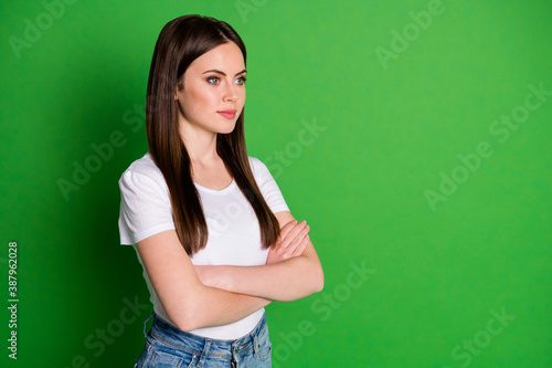 Profile photo of confident adorable accountant dressed casual outfit arms folded look empty space isolated green color background © deagreez