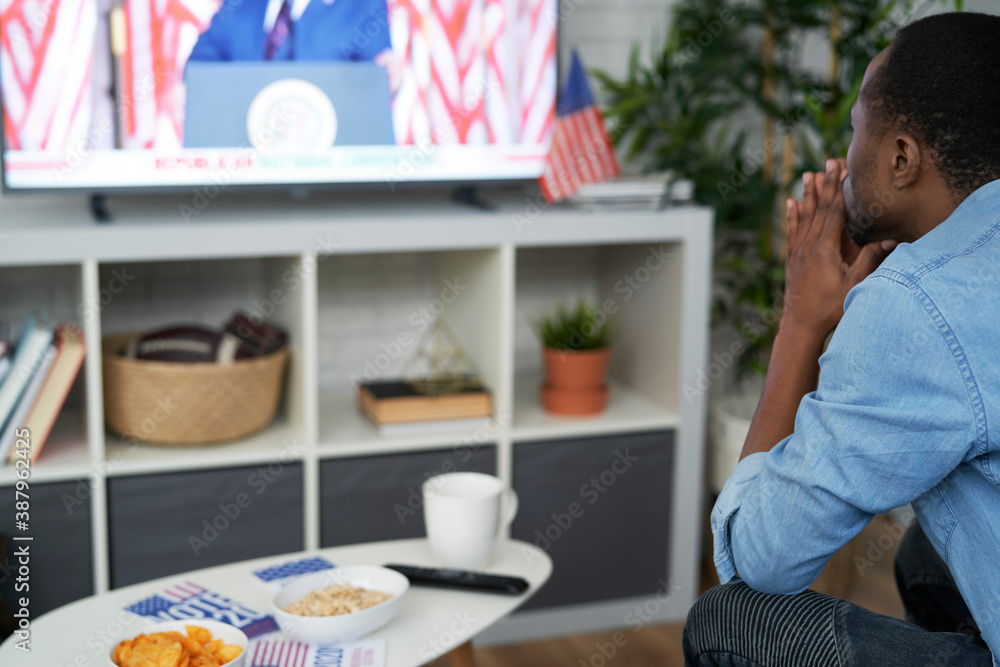 Fototapeta premium Black man stressed while watching USA election results
