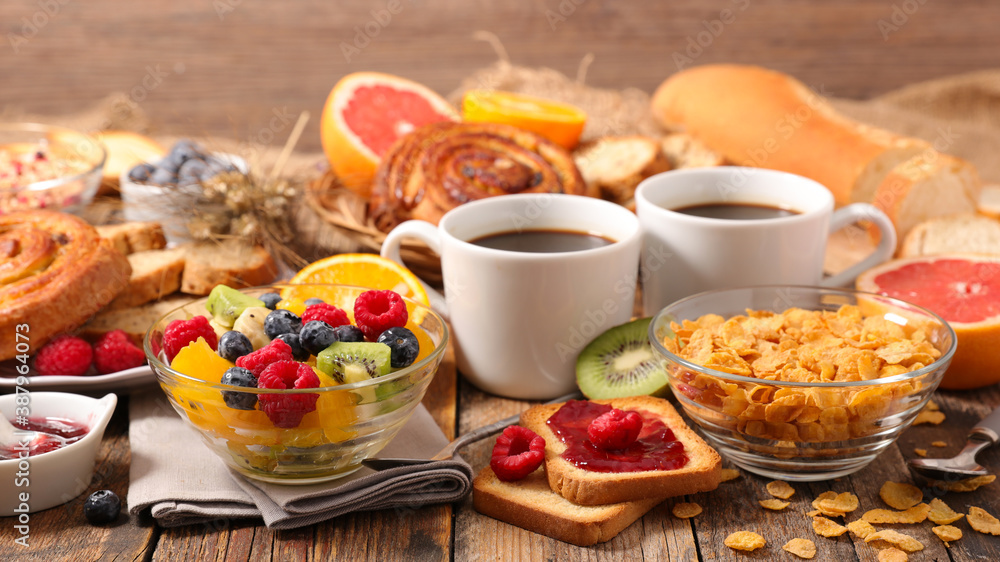 breakfast with coffee cup, fresh fruit, cereal and bread breakfast with coffee cup, fresh fruit, cereal and bread