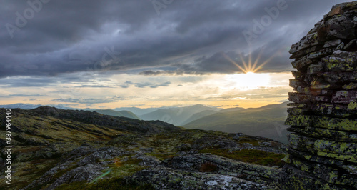 Cairn outdoors in nature during golden hour and sunset. Panoramic view. Travelling and landscapes concept.