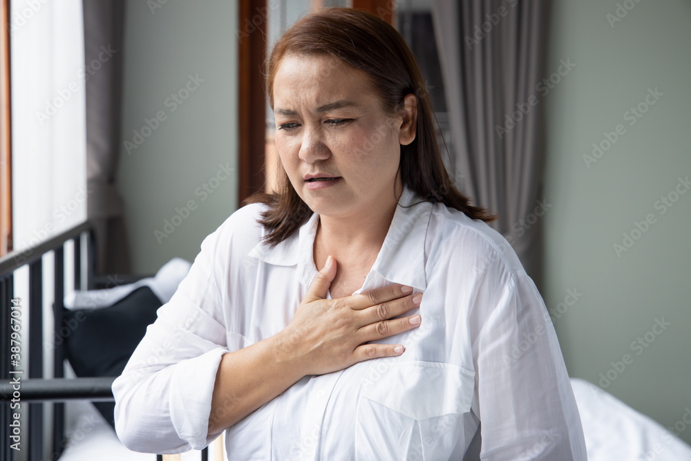 sick middle aged asian woman suffering from hearth attack or cardiac arrest sick middle aged asian woman suffering from hearth attack or cardiac arrest