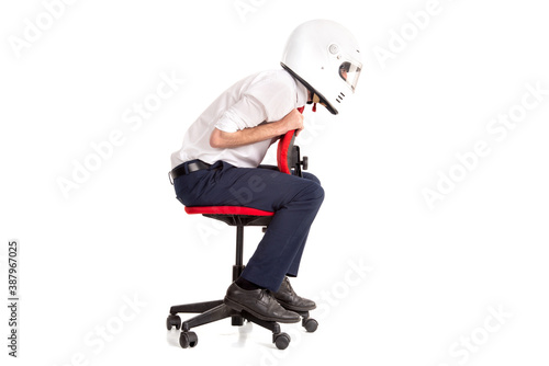 Businessman with helmet racing in a chair photo