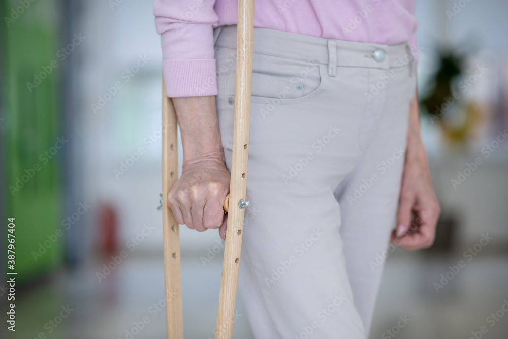 Close up of elderly woman with a crutch