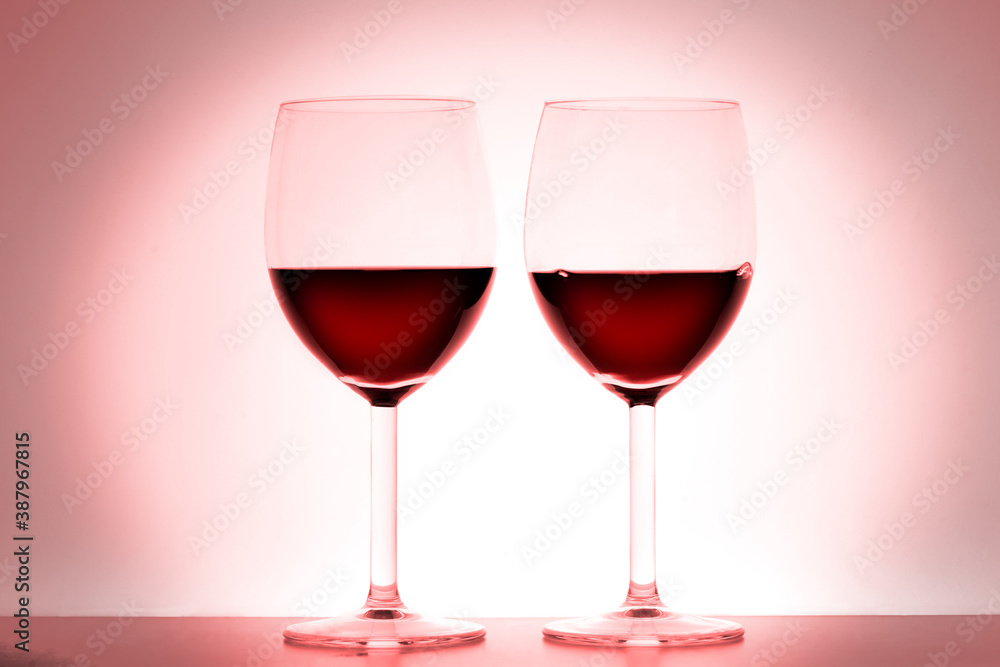 two wine glasses on red background with copy space for your text two wine glasses on red background with copy space for your text