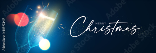 Merry Christmas and Happy New 2021 Year background with champagne glasses, lights and bokeh effect.
