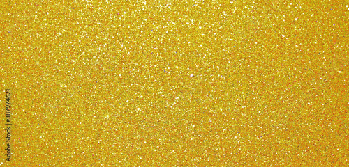 Christmas gold glitter background, golden shiny glittering shimmer pattern. Glittery sequins and gold foil confetti shine backdrop, Xmas card shimmer and luxury tinsel, gleam light effect background