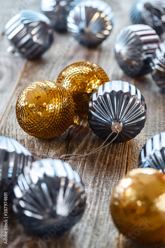 Lots of Christmas blue and gold balls on wooden background.