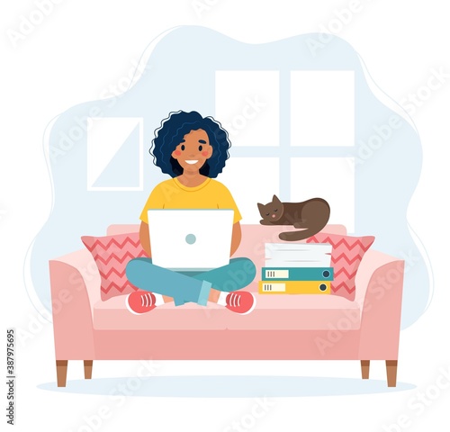 Home office concept, woman working from home sitting on a sofa, remote work concept