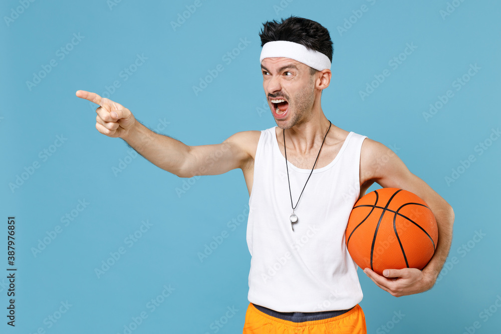 Angry fitness man basketball player with thin skinny body