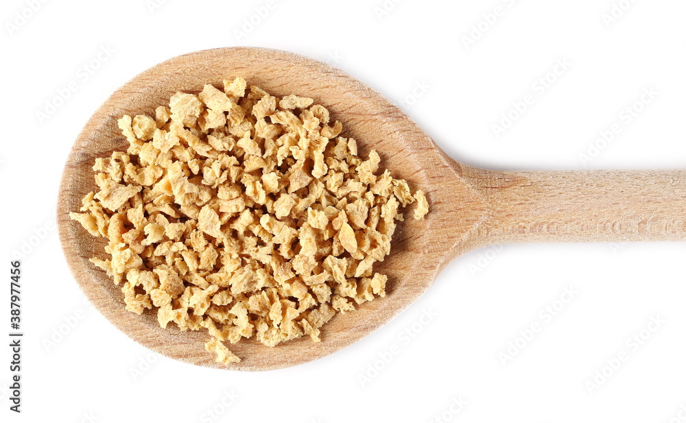 Soy flakes pile in wooden spoon isolated on white background, top view Soy flakes pile in wooden spoon isolated on white background, top view