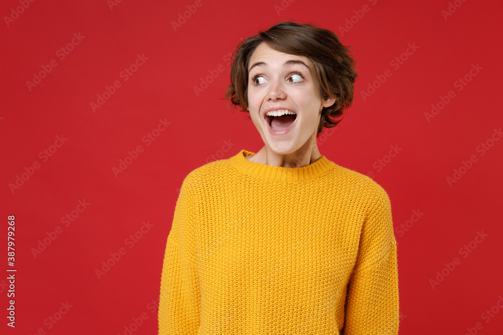 Smiling Brunette Woman Wearing a Yellow Sweater, and Playing