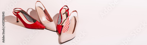 leather heeled shoes on beige background, banner