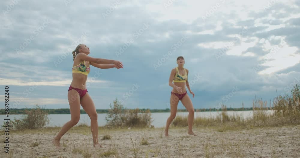 beach volleyball players are training outdoors, two sportswomen are passing and attacking, slow motion beach volleyball players are training outdoors, two sportswomen are passing and attacking, slow motion
