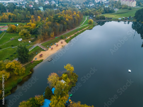 River in a forest Park with a beach on an autumn cloudy day  photo from a drone.