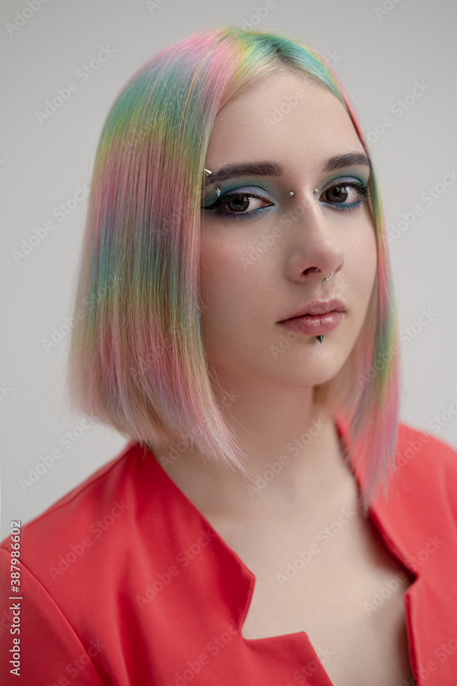 Portrait of a young beautiful informal blonde girl with dyed hair. Red jacket suit on the naked body. Studio photoshoot on a white background. Portrait of a young beautiful informal blonde girl with dyed hair. Red jacket suit on the naked body. Studio photoshoot on a white background.
