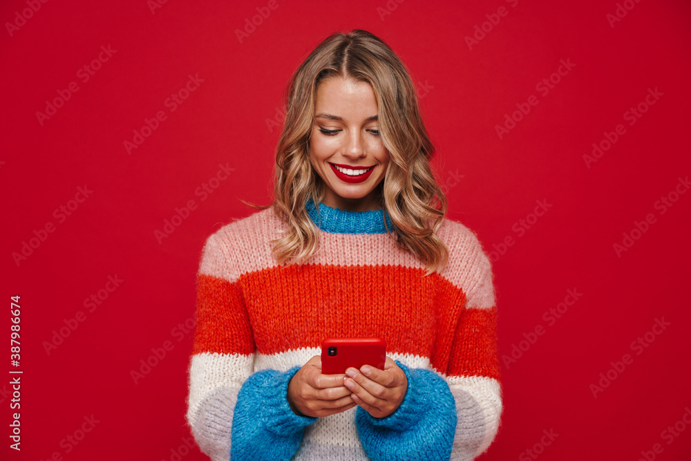 Nice caucasian happy girl smiling and using mobile phone