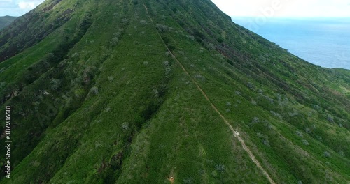 4K aerial drone forward tracking and sending motion view of the very Steep hiking trail up an abandoned railroad track on Koko Crater, with dramatic ocean & city views,Honolulu,Oahu,Hawaii,USA photo