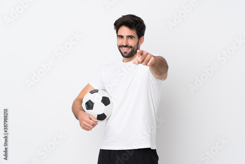 Young handsome man with beard over isolated white background points finger at you with a confident expression