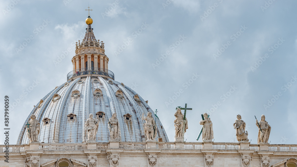 Statues of saints at Saint Peter Basilica dome in Vatican city, in the center of Rome, Italy, closeup, details.