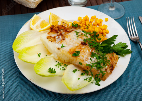 Fotografija Delicate baked pink cusk-eel fillet with side dish of fresh endive leaves, pickl