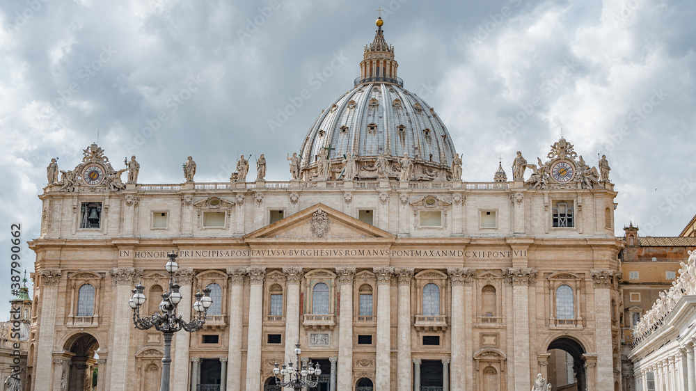 Dramatic view over Saint Peter Basilica in Vatican city, in the center of Rome, Italy, with heavy clouds.