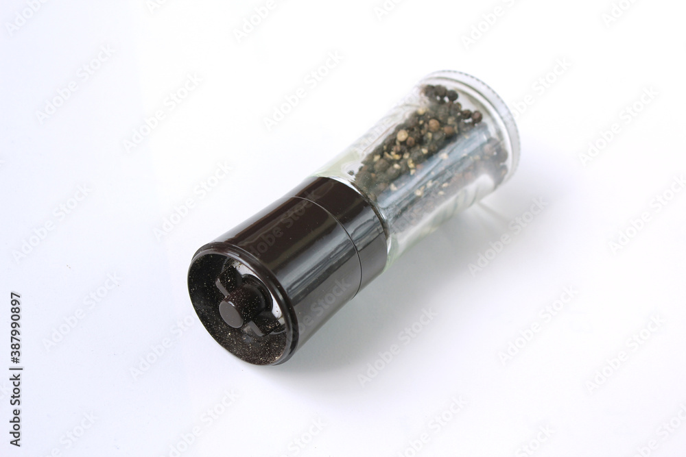 Glass black pepper corns shaker isolated on white background Glass black pepper corns shaker isolated on white background