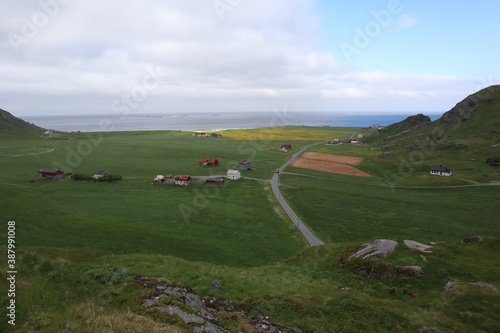 Uttakleiv / Norway - June 17 2019: Farmland between ocean and hills on Lofoten Islands