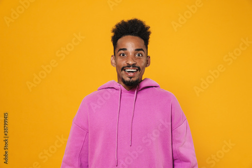 Excited african american guy smiling and looking at camera