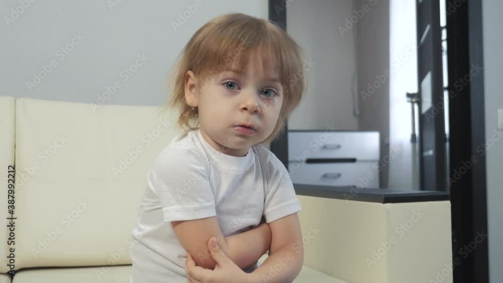 little a girl offended hugs herself with her hands. angry blonde girl indoors lifestyle little a girl offended hugs herself with her hands. angry blonde girl indoors lifestyle