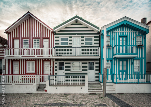 Tradittional fishermen's colorful houses in Costa Nova, Aveiro, Portugal. Tourism atraction. Red , green and blue stripes