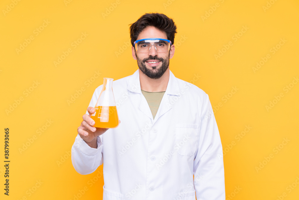 Young scientific man over isolated yellow background smiling a lot Young scientific man over isolated yellow background smiling a lot