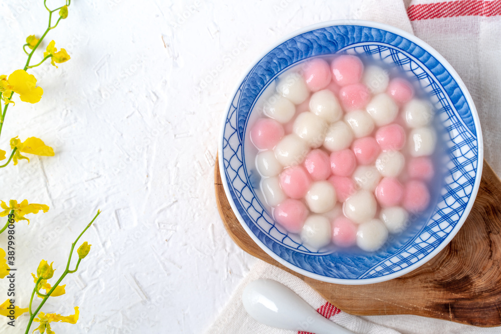 Top view of red and white tangyuan in blue bowl on white background for Winter solstice. Top view of red and white tangyuan in blue bowl on white background for Winter solstice.