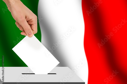 hand drops the ballot election against the background of the Italy flag, concept of state elections, referendum