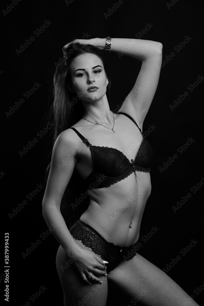 Obraz premium Beautiful sexy woman in blue underwear on dark background, perfect female body, studio shot
