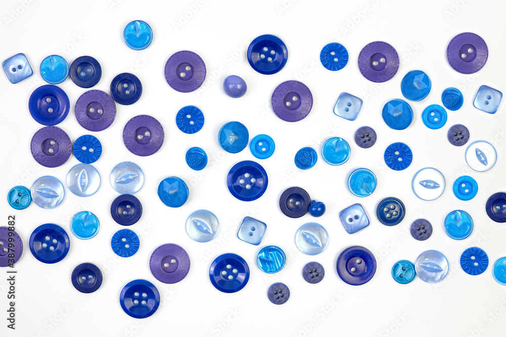Many different blue buttons close-up. The background. Many different blue buttons close-up. The background.