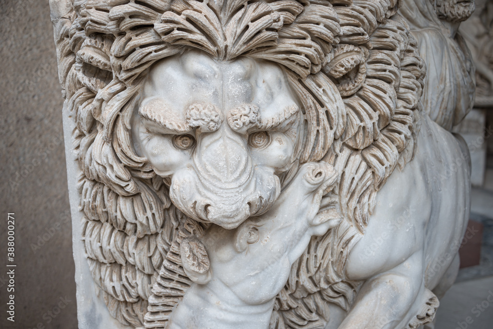 Ancient figure of a fearful lion killing a zebra in Rome, Italy, closeup, details.
