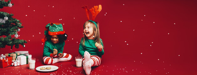Kids having fun eating christmas cookies