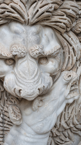 Ancient figure of a fearful lion killing a zebra in Rome, Italy, closeup, details.