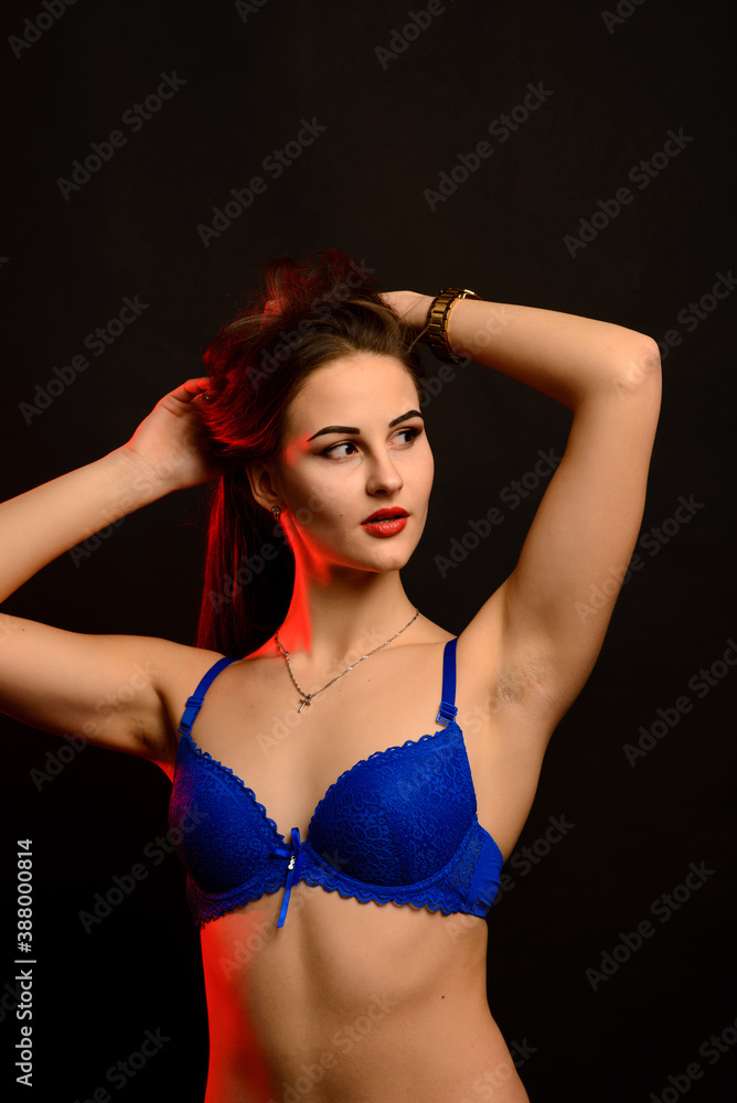 Beautiful sexy woman in blue underwear on dark background, perfect female body, studio shot