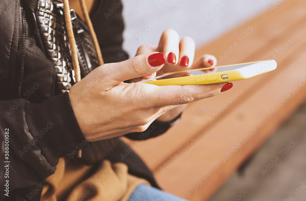 Woman using phone outdoors on a sunny day Woman using phone outdoors on a sunny day