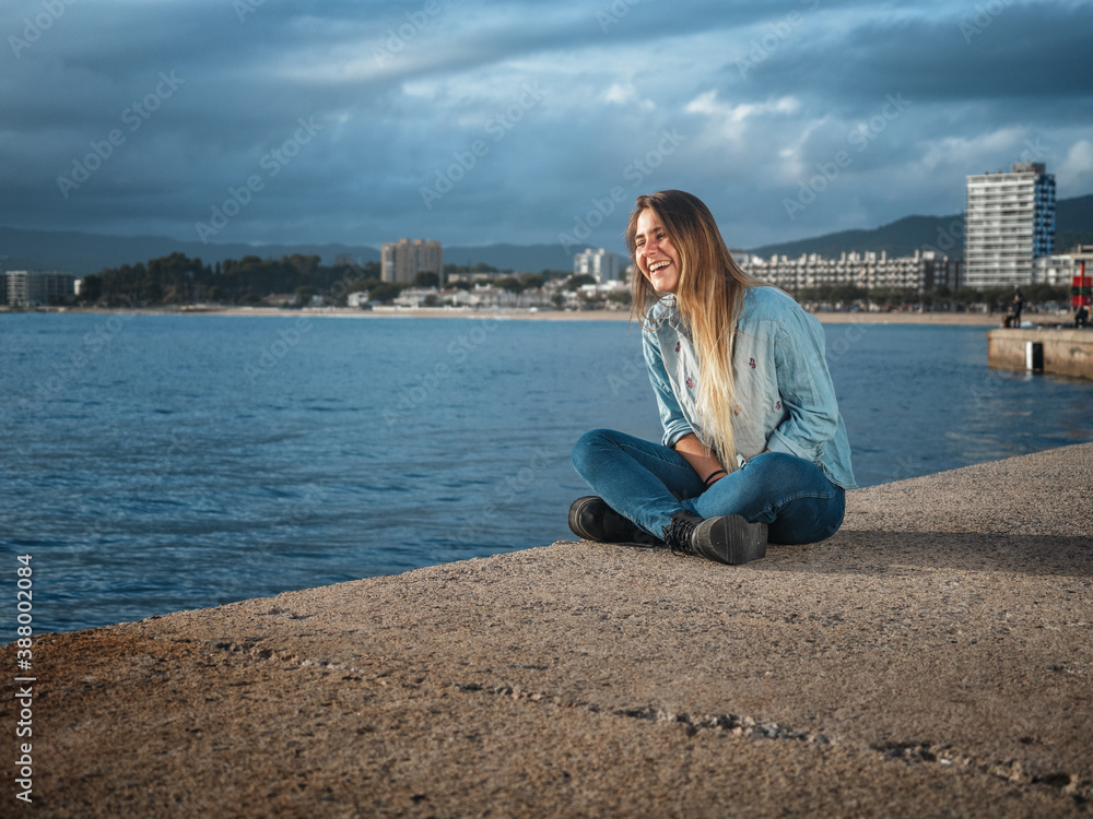 young woman smiling in a mediterranean sea port