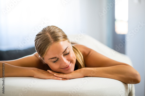 Beautiful woman is relaxing massage at her home. Stress relief after work.