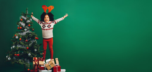 Excited kid standing on gift boxes