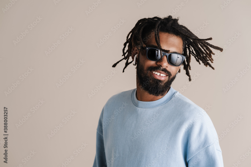 Cheerful african american guy in earphones dancing at camera Cheerful african american guy in earphones dancing at camera