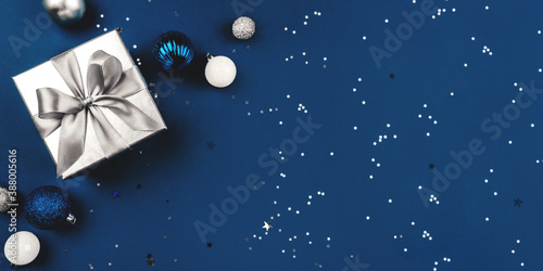 Blue Christmas background of gift box and decorations. The concept of the winter holidays. Flat lay, top view, copy space.
