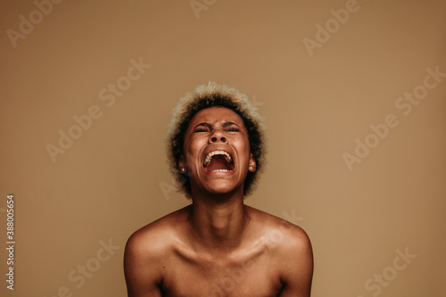 Fototapeta Portrait of african american female shouting in pain