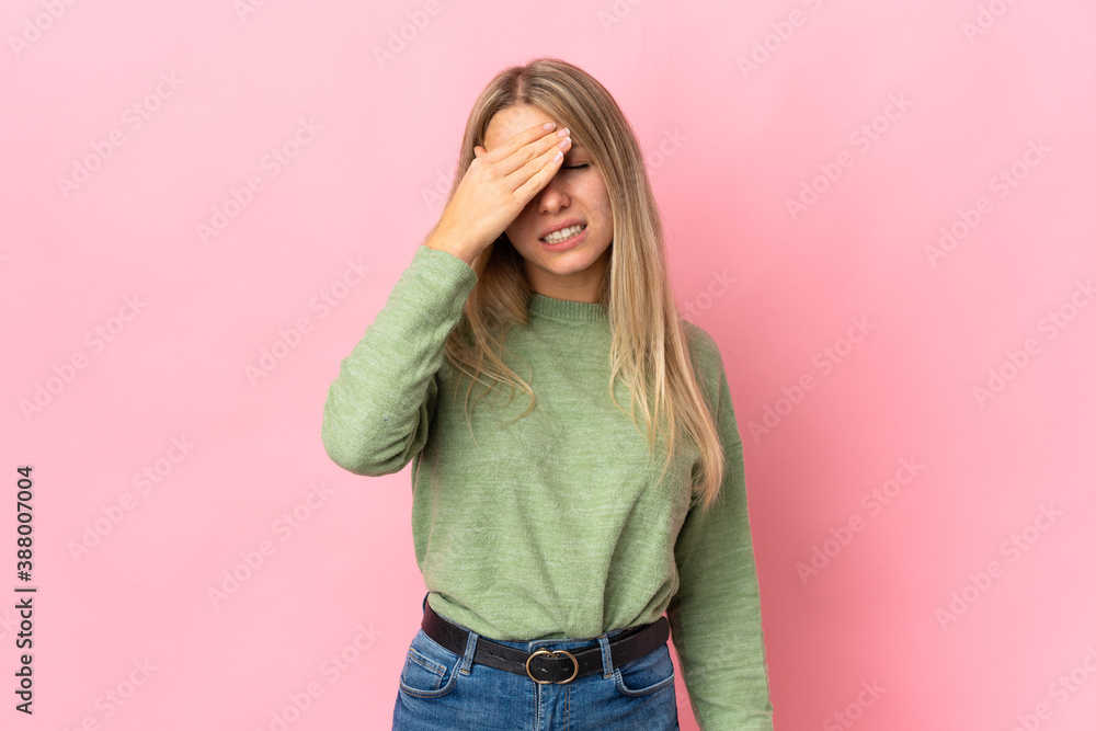 Young blonde woman isolated on pink background with headache Young blonde woman isolated on pink background with headache