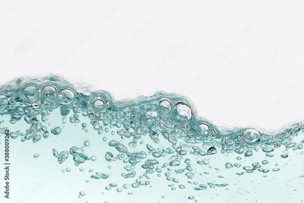 Close up blue water splash with air bubbles. Fresh and clean surface aqua flowing in wave and clean water on white background isolated. Advertising image with free space for your work Close up blue water splash with air bubbles. Fresh and clean surface aqua flowing in wave and clean water on white background isolated. Advertising image with free space for your work